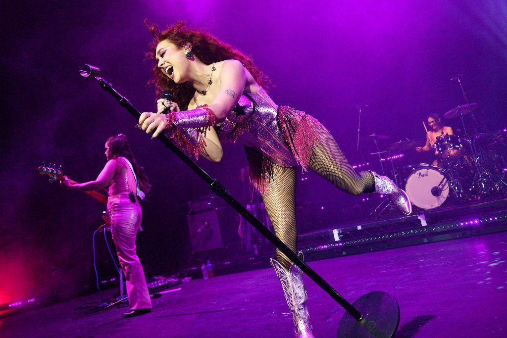 Chappell Roan leans into the microphone as she plays London's Brixton Academy in October 2024