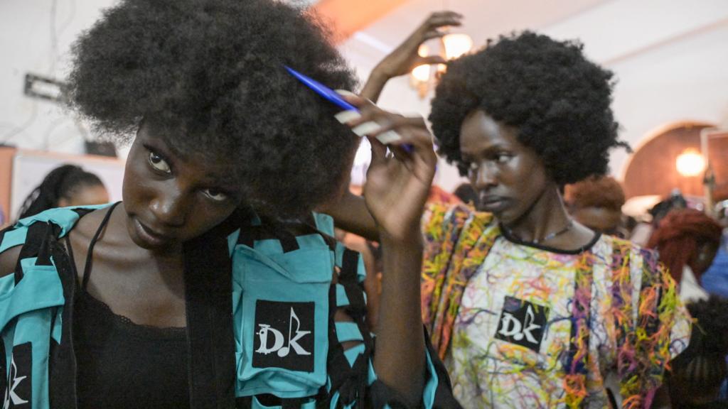 Models prepare backstage before the main fashion show of the Africa Fashion Week, at the delight technical college in Nairobi, Kenya - 9 December 2023