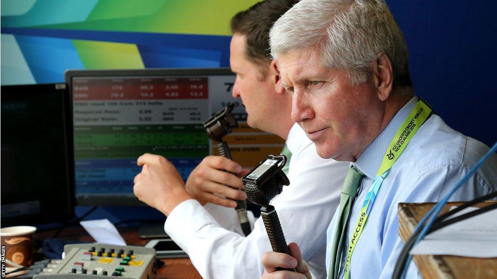 Alan Wilkins holding microphone