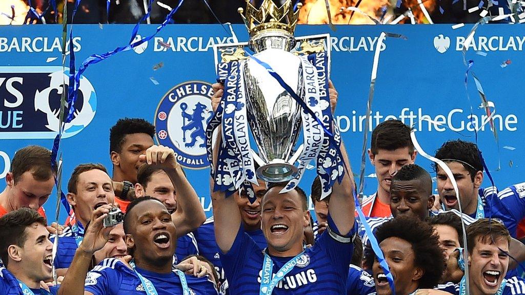 English defender John Terry holds up the trophy during the presentation of the Premier League trophy after the English Premier League football match between Chelsea and Sunderland at Stamford Bridge in London