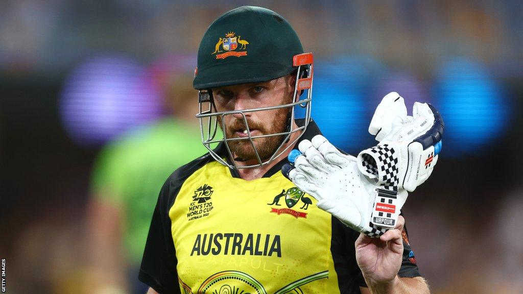 Aaron Finch raises his gloves as he walks off after making 63 against Ireland in the 2022 Men's T20 World Cup