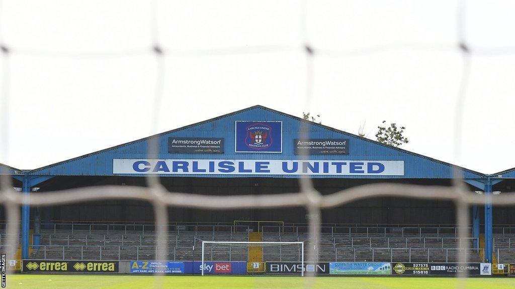 Carlisle United's Warwick Road terrace viewed through a goalnet