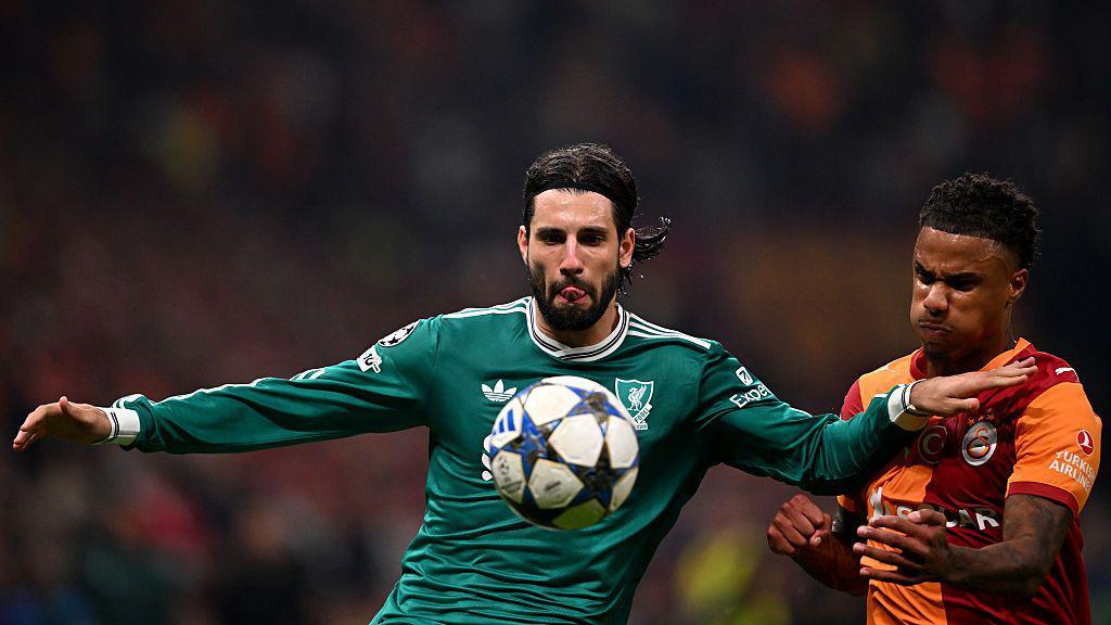 Dominik Szoboszlai is challenged by Ismail Jakobs