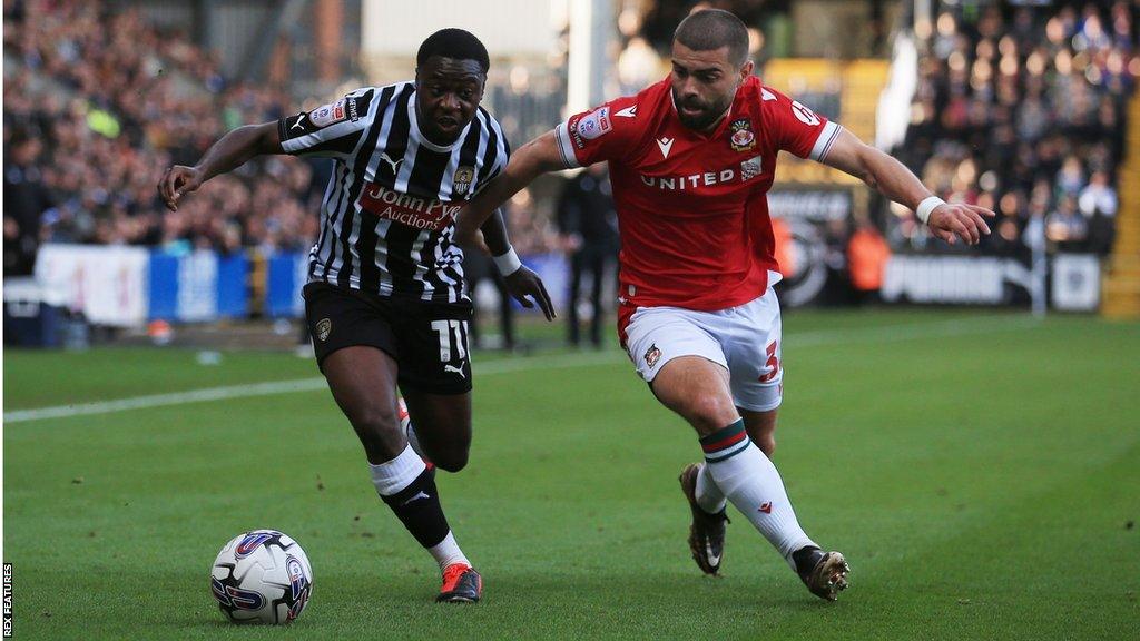 Wrexham's Elliot Lee vies with Notts County's Aaron Nemane.