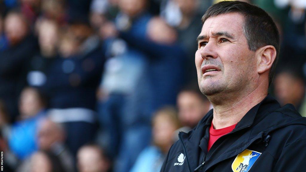 Nigel Clough watches his Mansfield Town side in action against Notts County