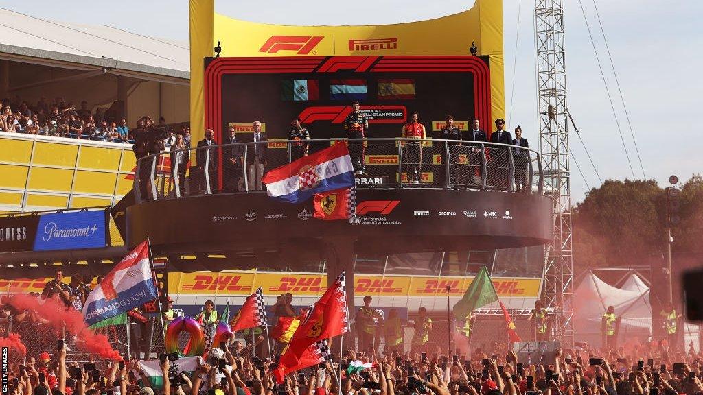 Ferrari fans mass on the Monza pit straight in front of the podium after the Italian Grand Prix