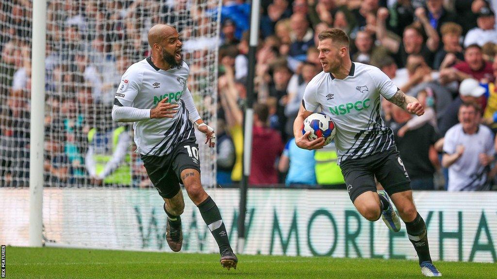 Derby County's James Collins holds the ball and celebrates his equaliser against Portsmouth at Pride Park