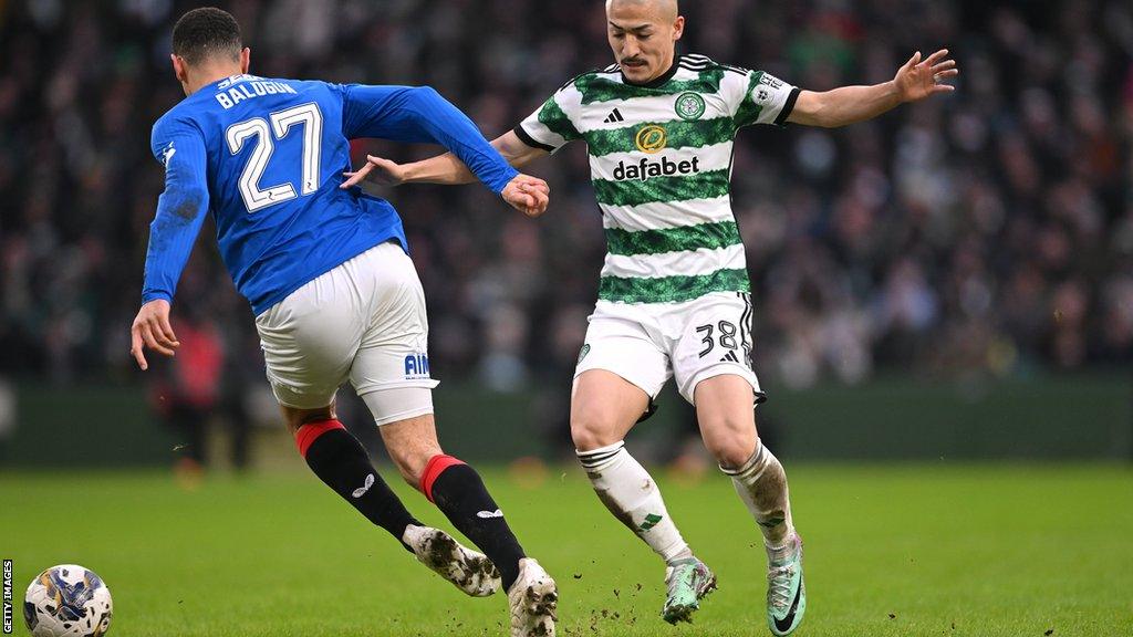 Celtic's Maeda and Rangers' Balogun battle for possession