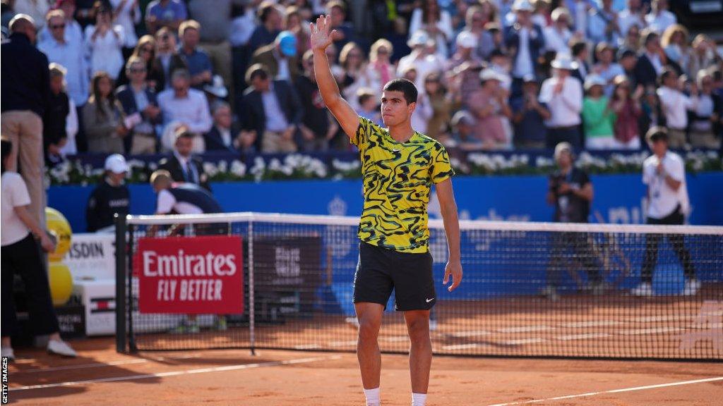 Carlos Alcaraz saluting the crowd after his win over Dan Evans