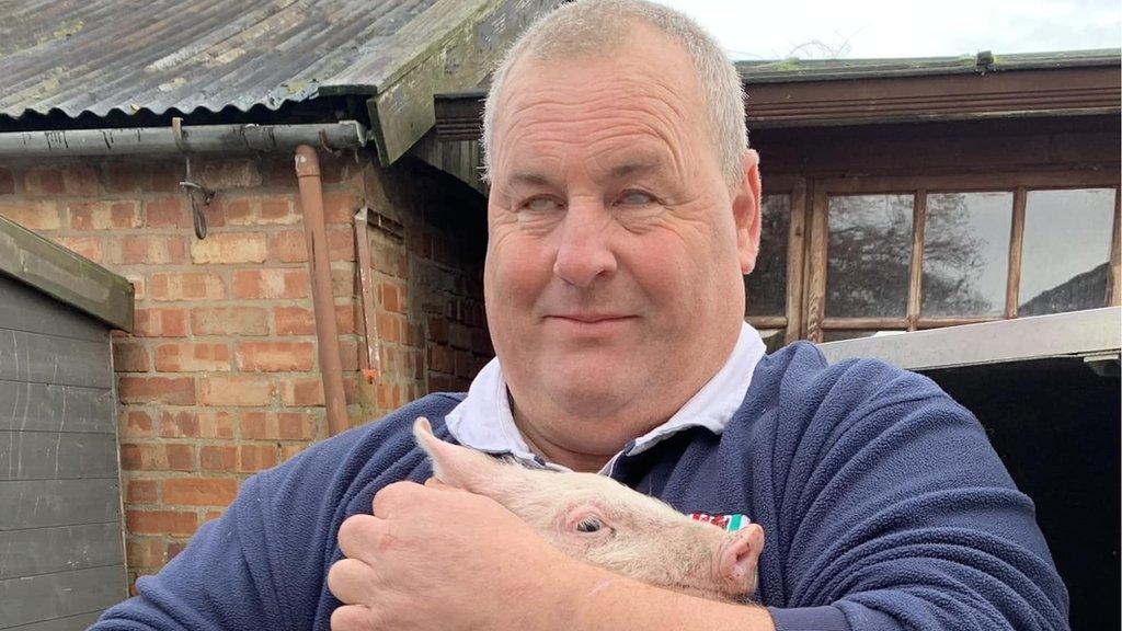 Mike Duxbury holding a pig