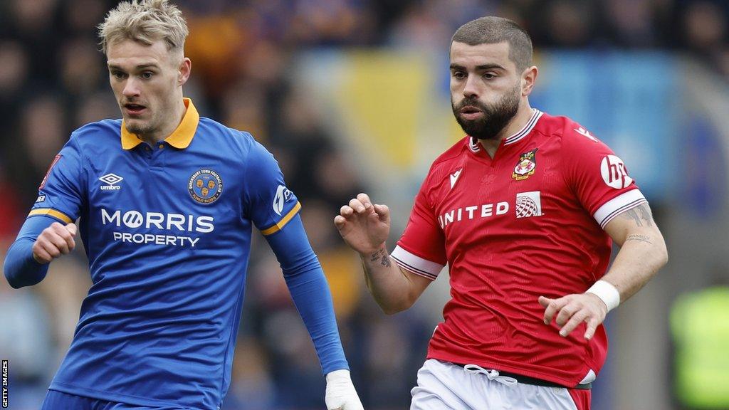 Elliot Lee (right) of Wrexham and Taylor Perry of Shrewsbury