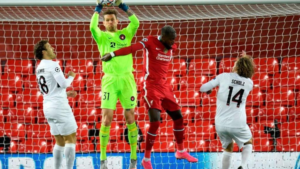 Divock Origi challenges for the ball for Liverpool