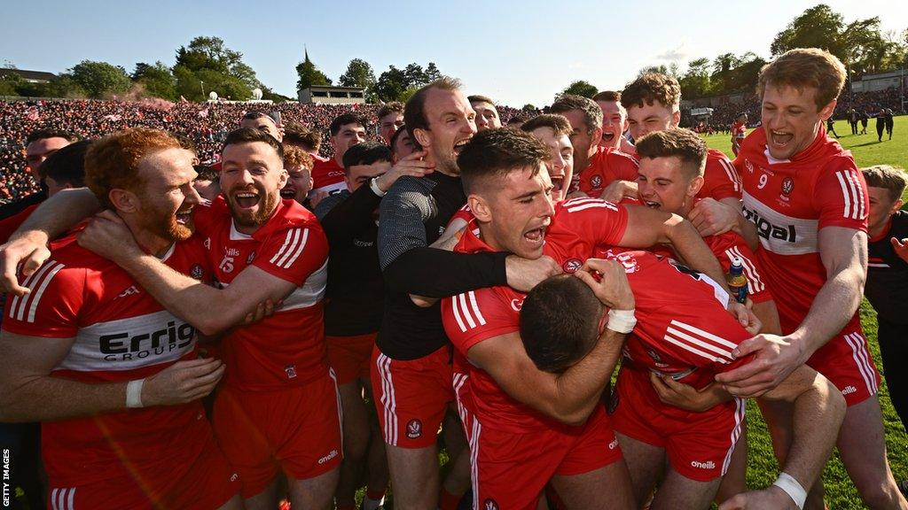 Derry players celebrate after the final whistle