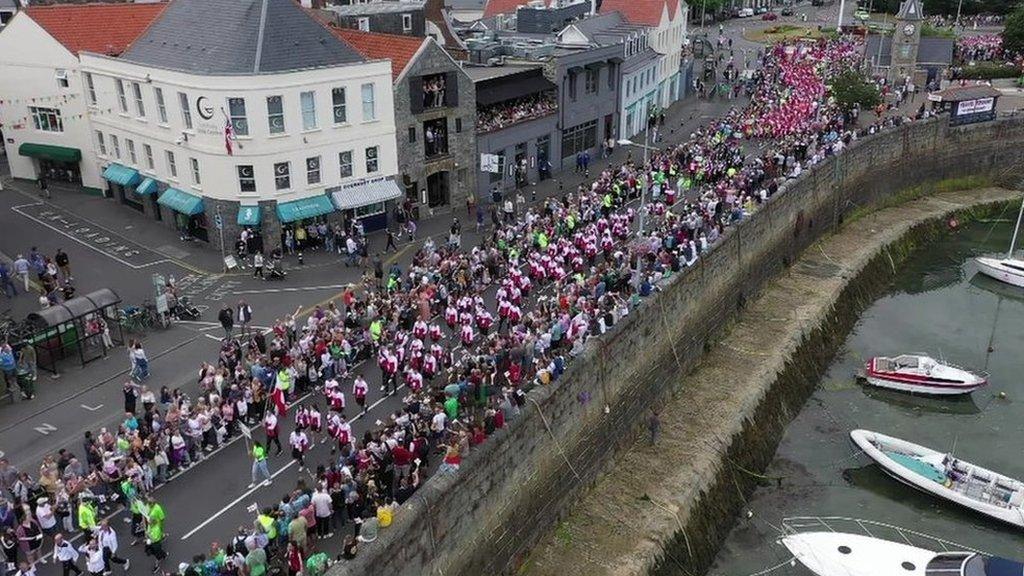 People lining the street in St Peter Port, Guernsey, for The Island Games 2023