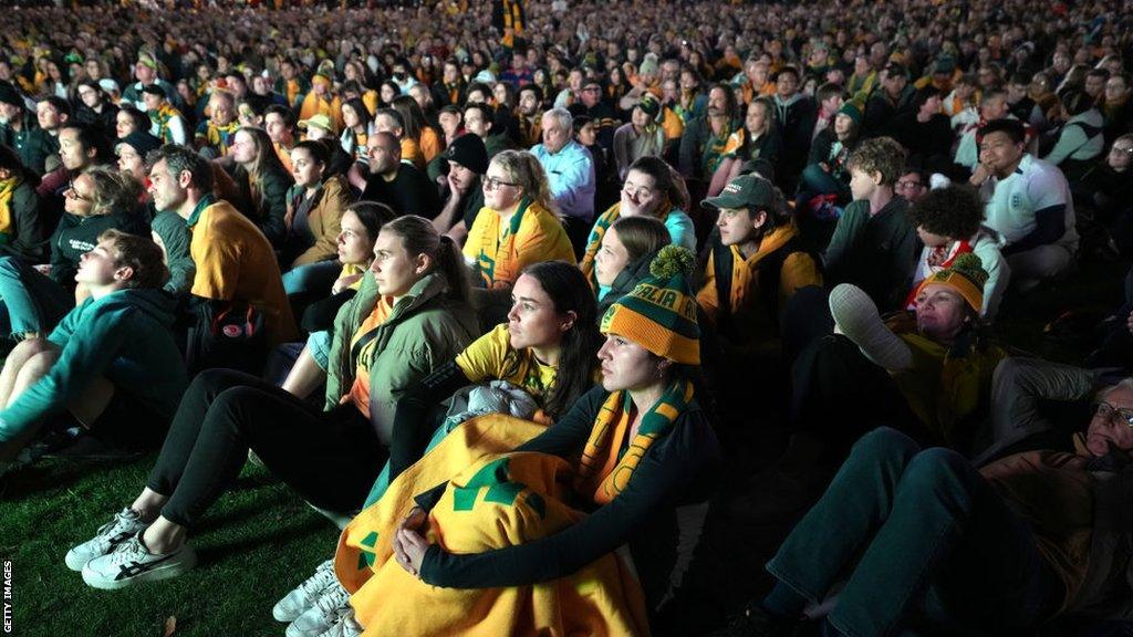 Fans watch the Australia v France match before England's game against Colombia