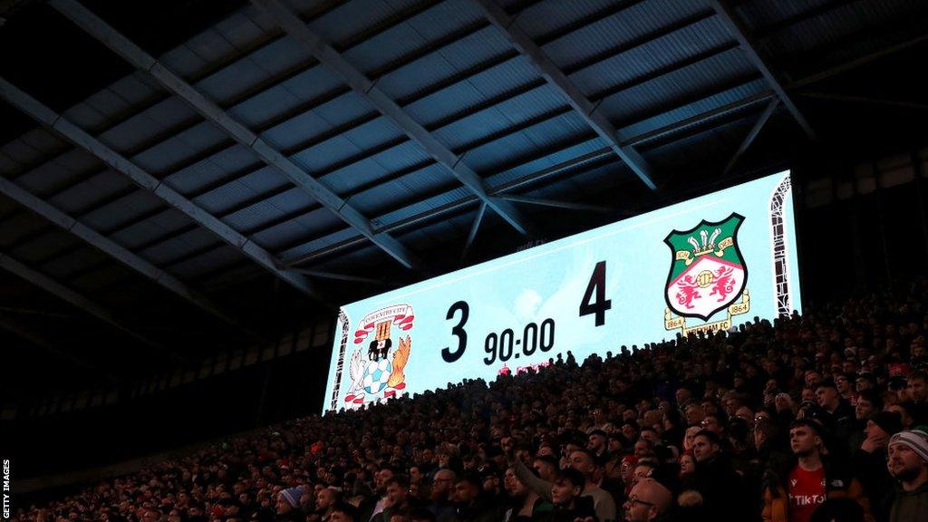 Wrexham fans in front of the scoreboard at Coventry last season