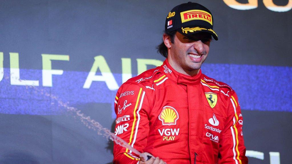 Carlos Sainz on the podium after finishing in third.