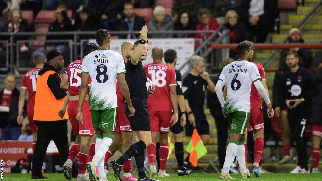 Leyton Orient and Lincoln players leave the field