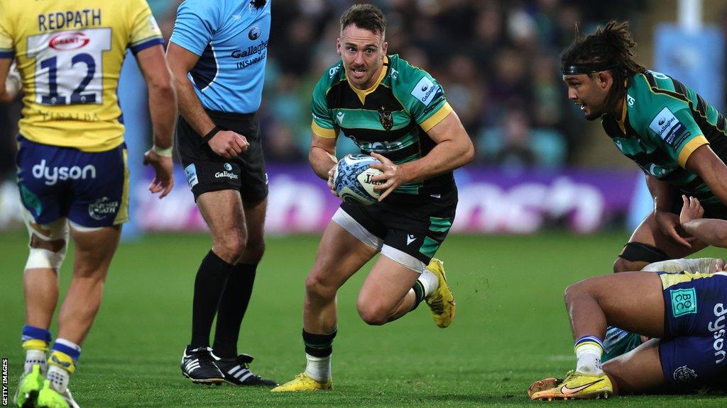 Tom James running with the ball for Northampton Saints