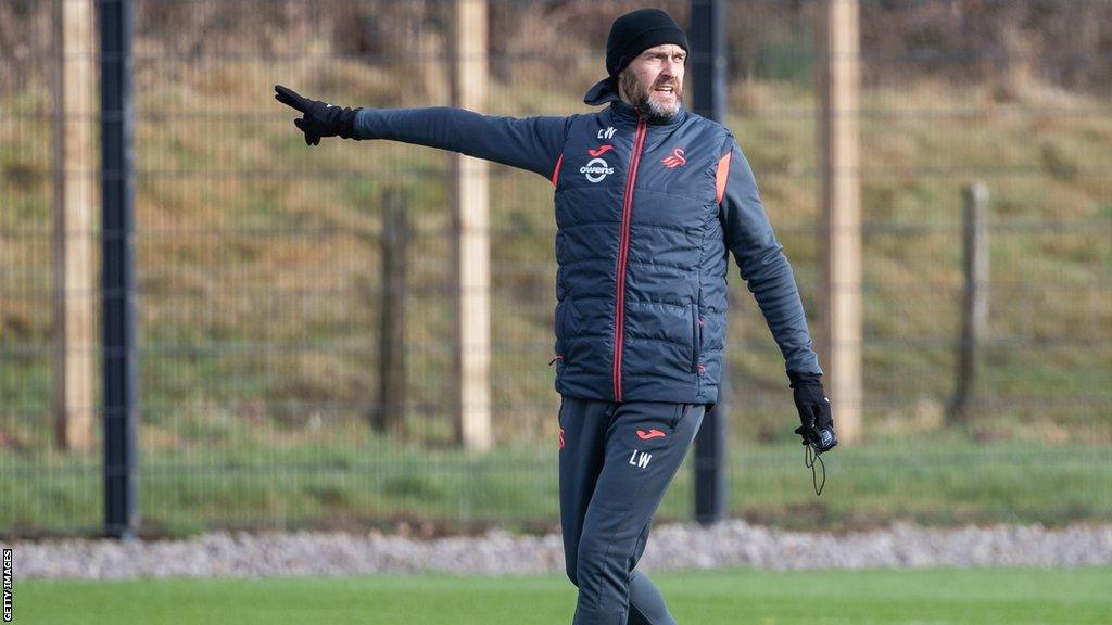 Swansea City boss Luke Williams gives directions to his players on the training ground