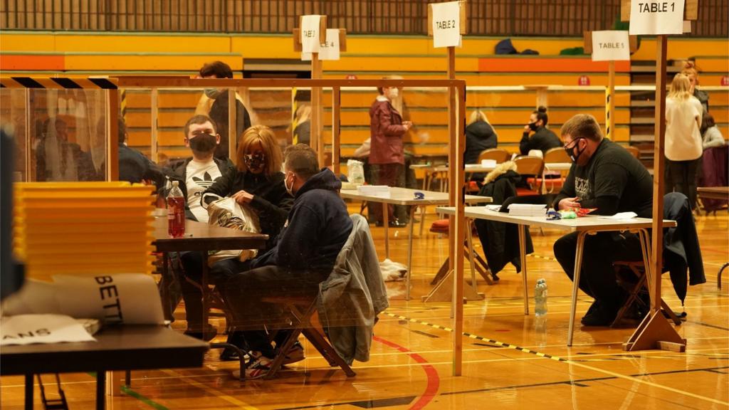 Election officials in face masks at Mill House Leisure Centre wait for ballot boxes to arrive before they can start counting in the Hartlepool parliamentary by-election, in Hartlepool