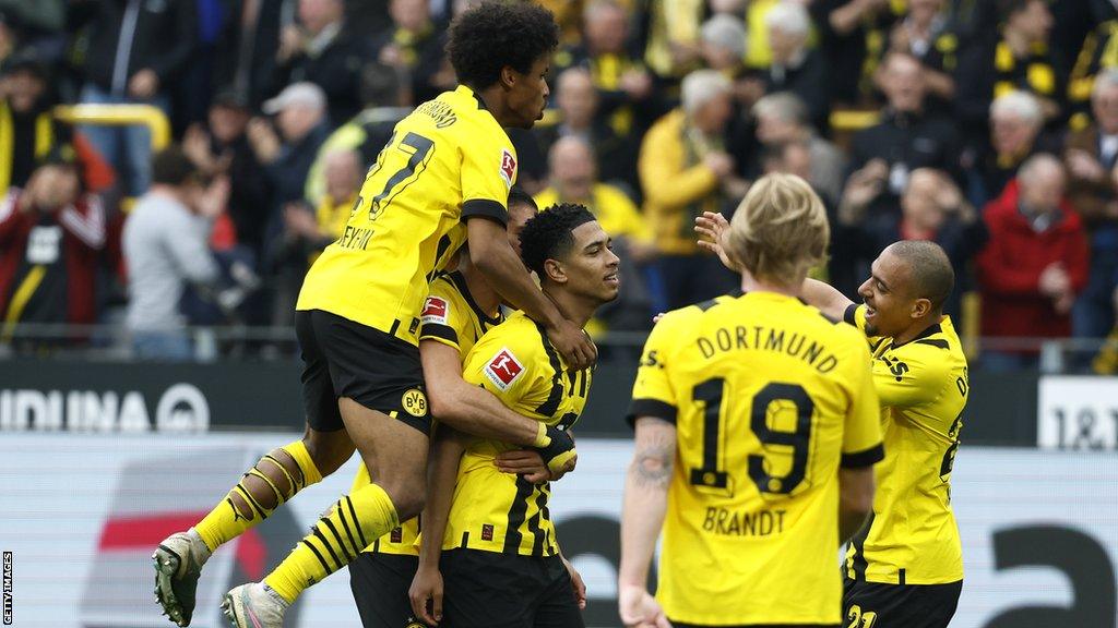 Jude Bellingham celebrating a goal against Wolfsburg with his team-mates