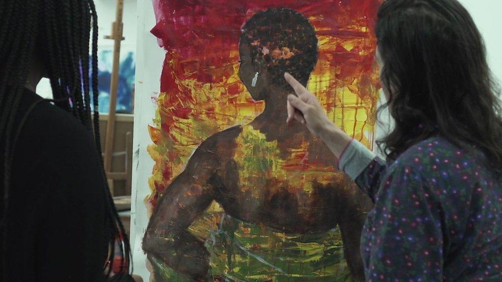 Woman pointing at painting