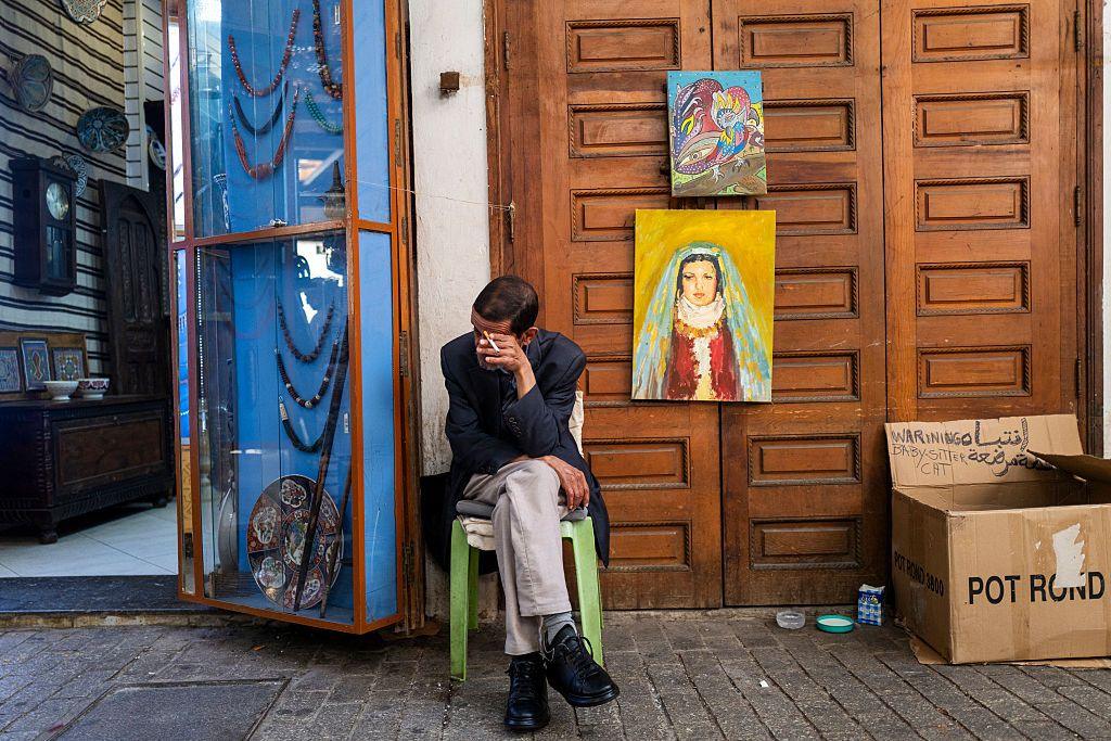 A shopkeeper waits for customers outside his store in a market area in Rabat.