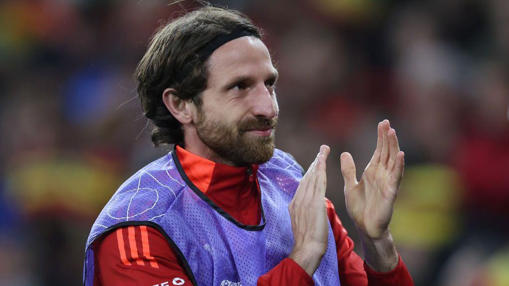 Joe Allen claps Wales fans earlier this season