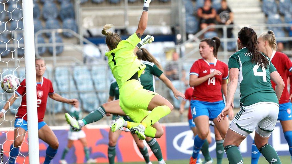 Sarah McFadden (number four) watches as her header goes into the Czech Republic net