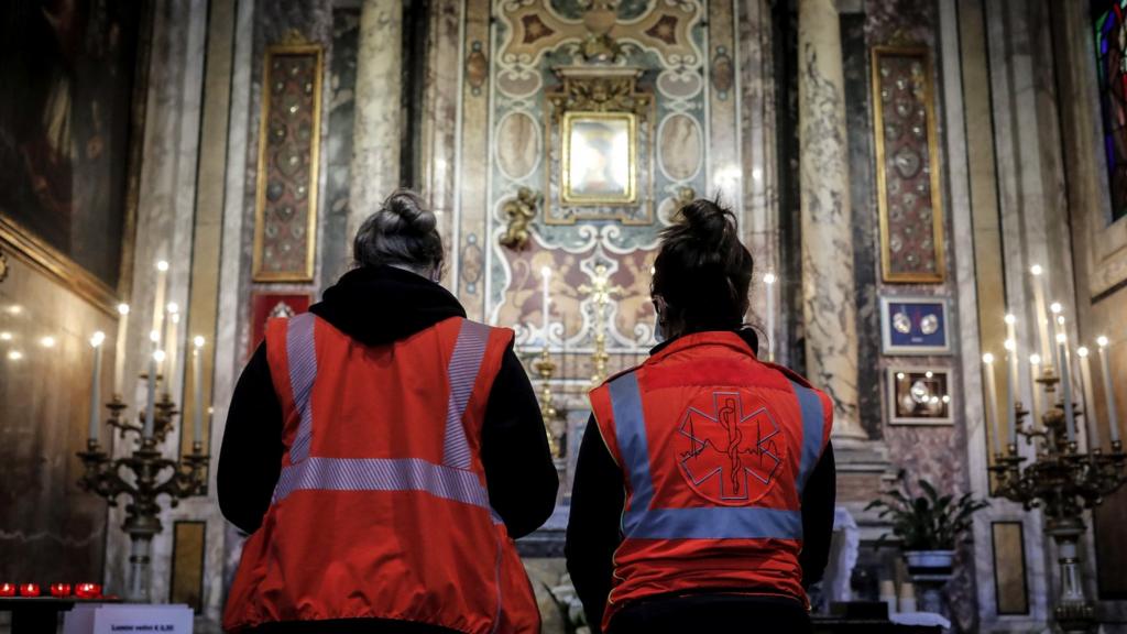 Emergency services personnel pause for a prayer in the Church of Santa Rita da Cascia alle Vergini, Rome, Italy, 27 March 2020