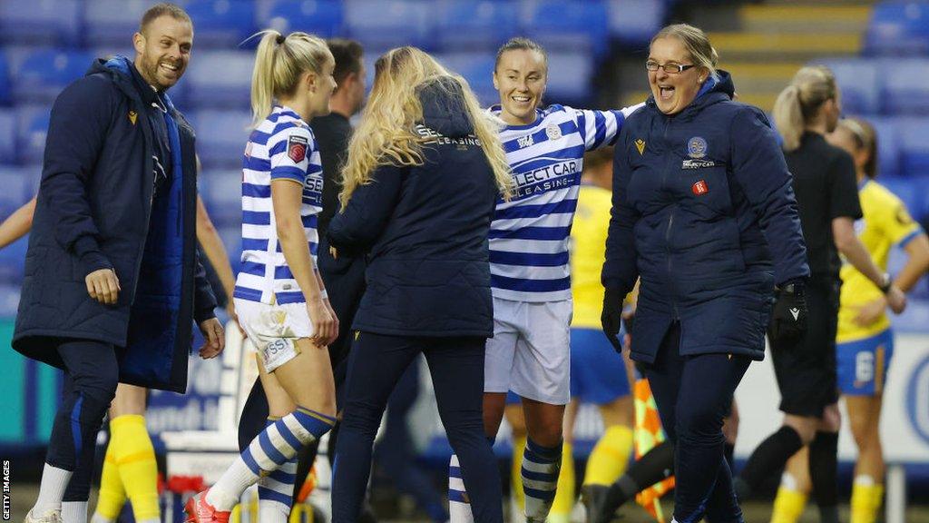 Kelly Chambers celebrates with players after a victory over Brighton in 2021