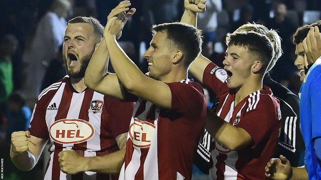 Exeter players celebrate progressing in the Carabao Cup