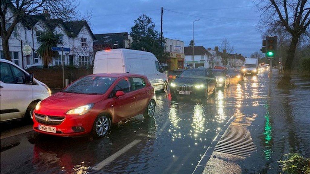 Cars driving through a flooded road