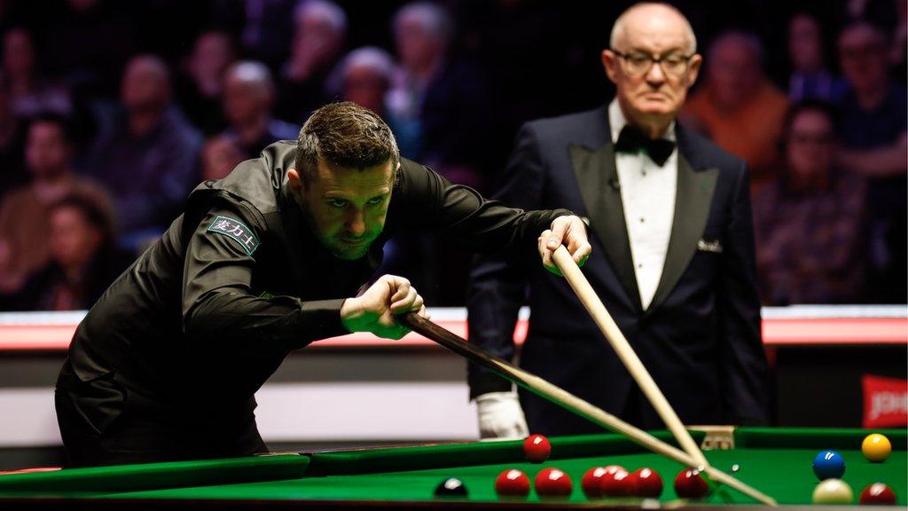 Mark Selby plays a shot with the rest