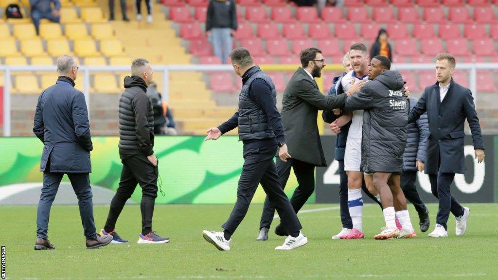 Roberto D'Aversa walks away after headbutting Thomas Henry