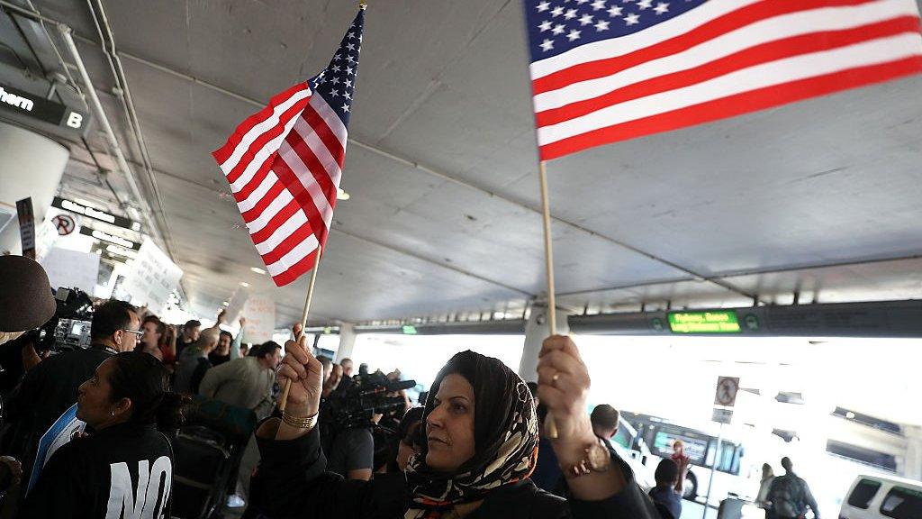 Woman holds American flags