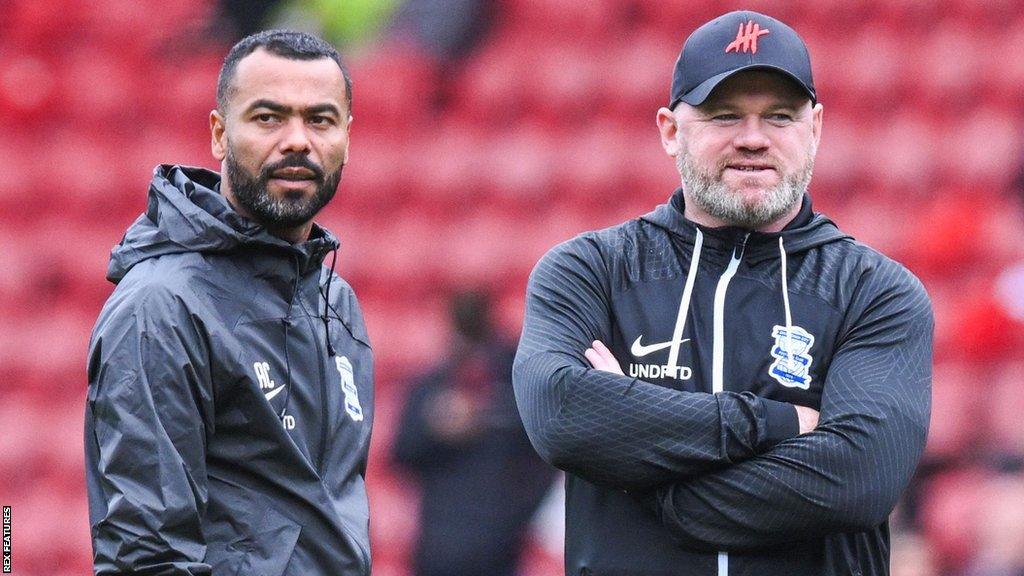 Ashley Cole and Wayne Rooney look on during Birmingham City's pre-match warm-up at Middlesbrough