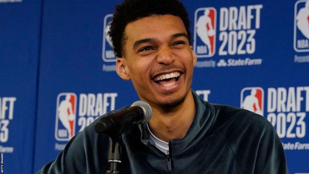 Victor Wembenyama laughs during media duties before Thursday's NBA Draft