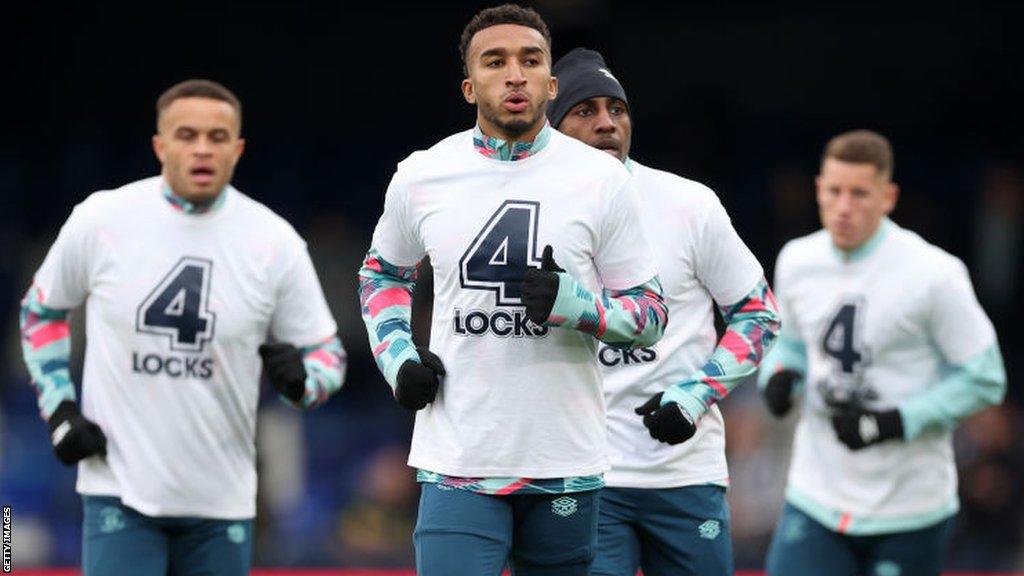 Luton players wear number four shirts in honour of convalescing captain Tom Lockyer