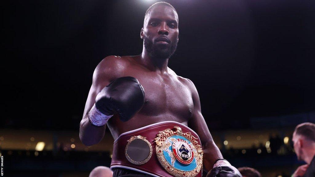 Lawrence Okolie celebrates after beating Poland's Michal Cieslak in February 2021