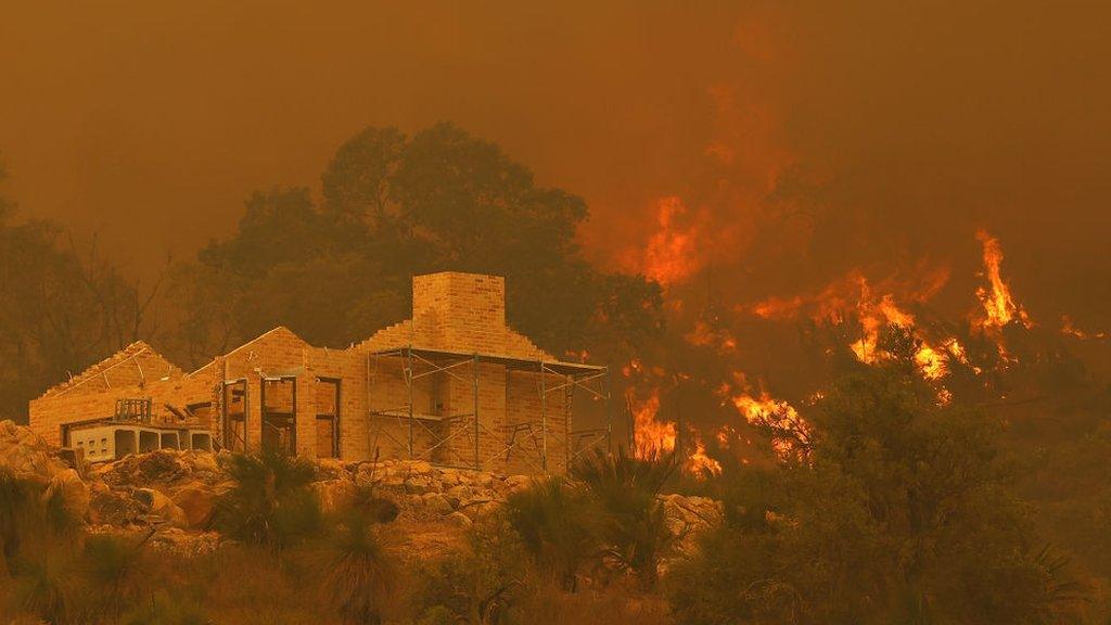 Flames surround a property under construction off Copley Road in Upper Swan on 2 February 2021 in Perth, Australia