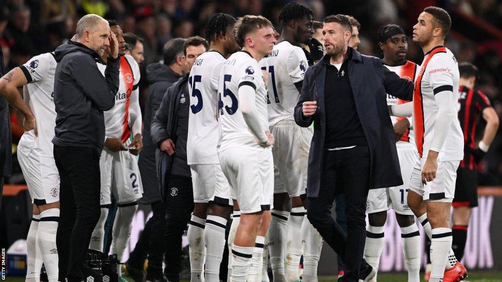 Luton players on the pitch after the games was stopped