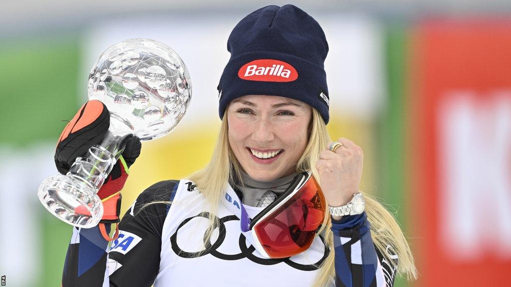 Mikaela Shiffrin holding a glass trophy