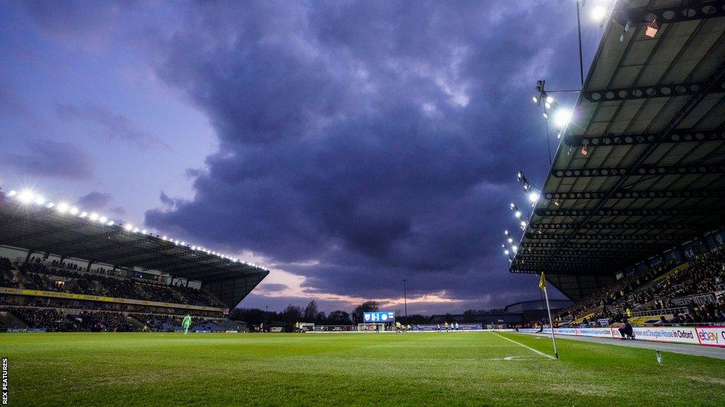 A general view of dark clouds over Oxford's stadium during a match