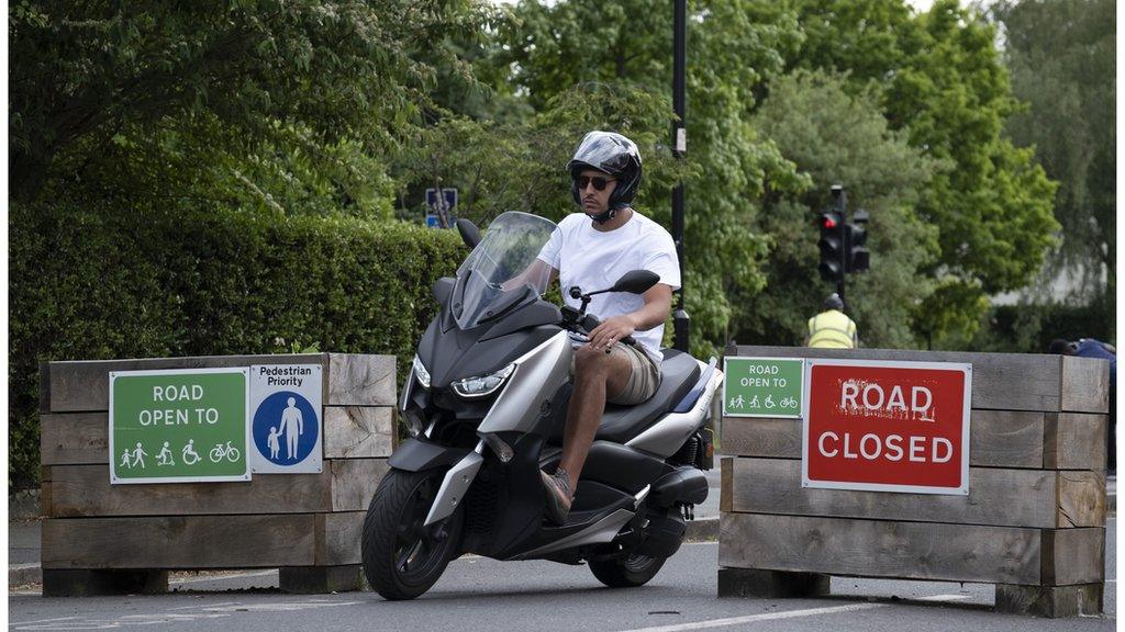 Motorcyclist and an LTN sign