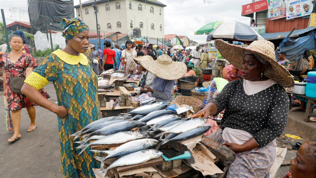 A customer speaks to a fish seller in Lagos, Nigeria - 2022