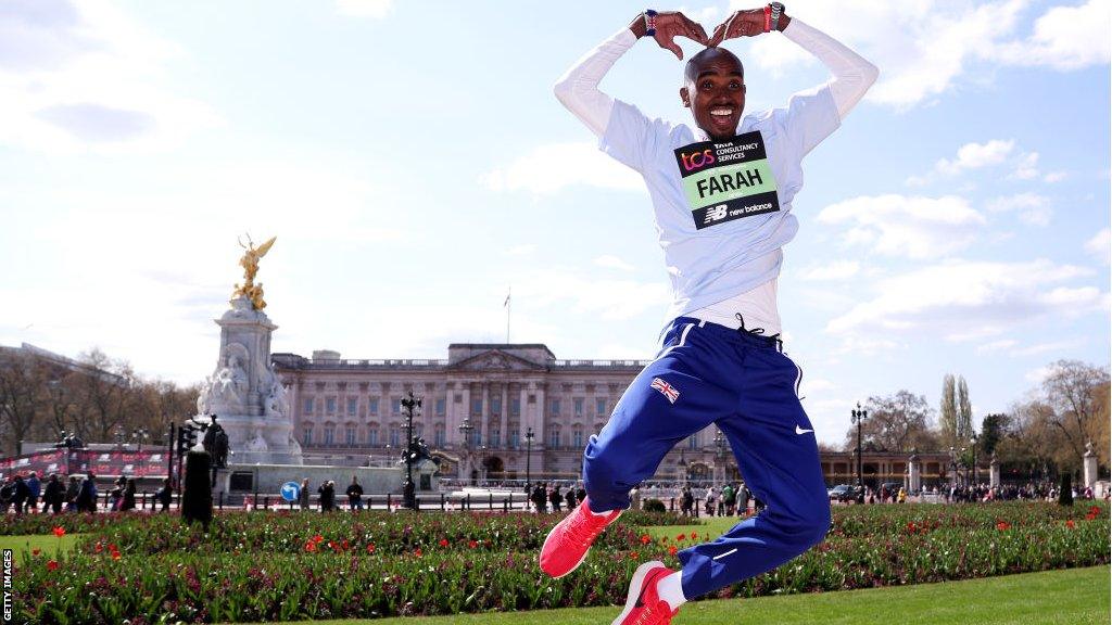 Mo Farah jumps in the air for a photograph in front of Buckingham Palace