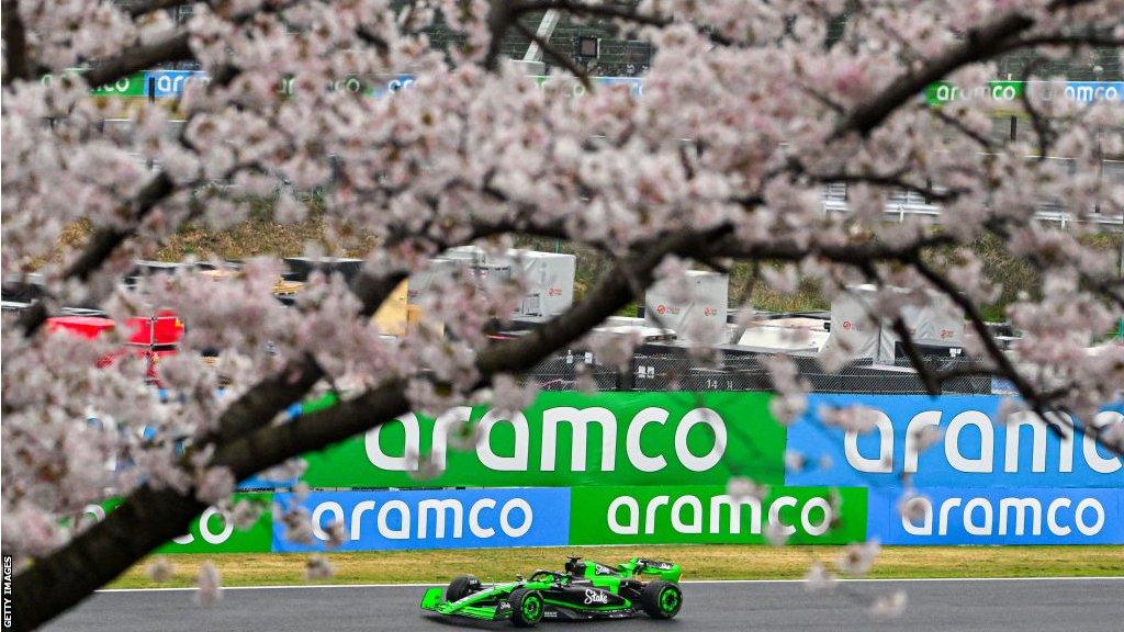 Valtteri Bottas driver near blossom tree at the Japanese GP