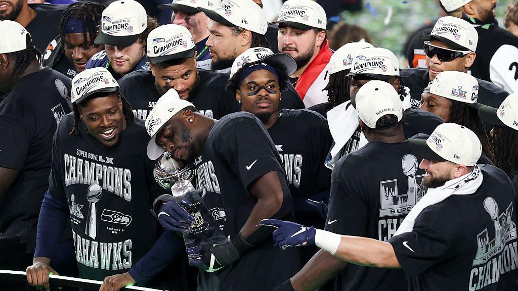 Seattle Seahawks players celebrate with the Lombardi Trophy
